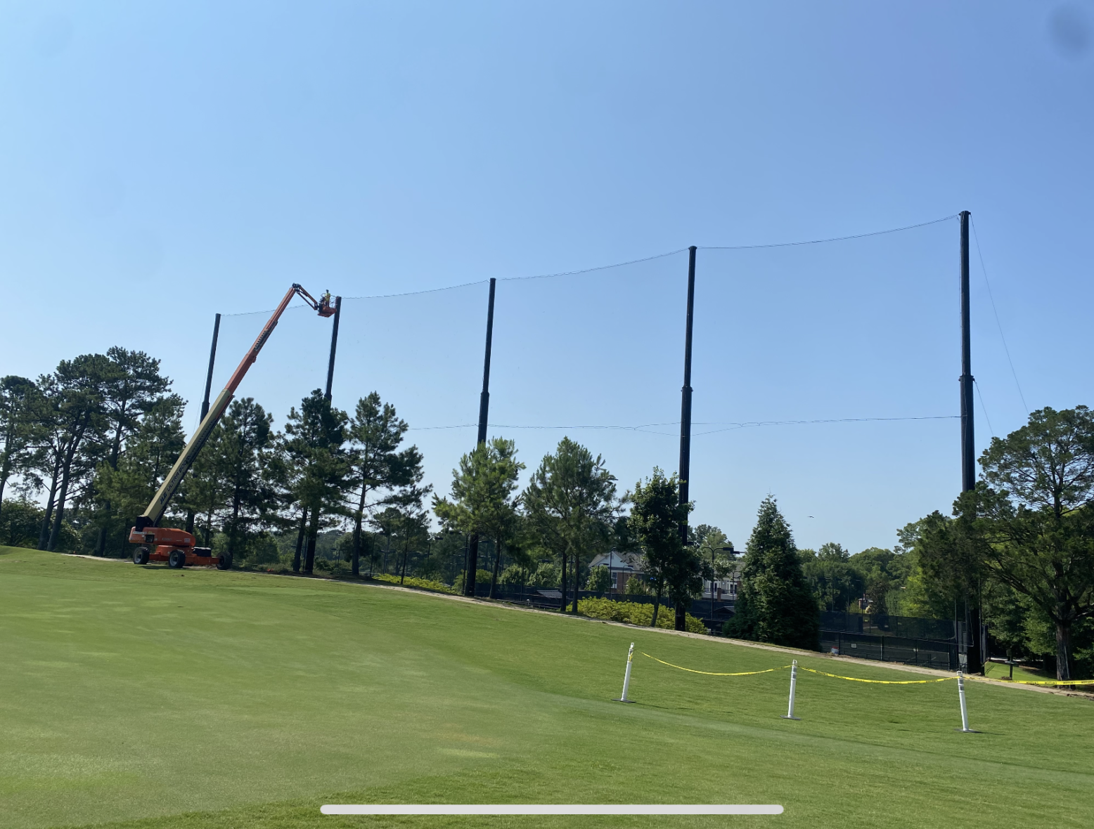 Installation of 200'L x 75'H netting system using aerial lift equipment at Carmel Country Club Driving Range